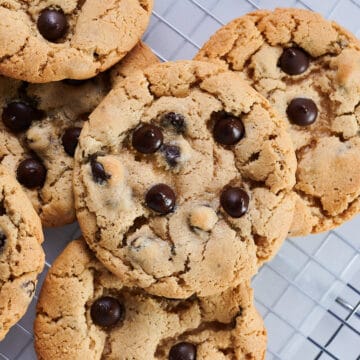 close up, overhead shot of freshly baked gluten-free, dairy-free chocolate chip cookies on a cooling rack